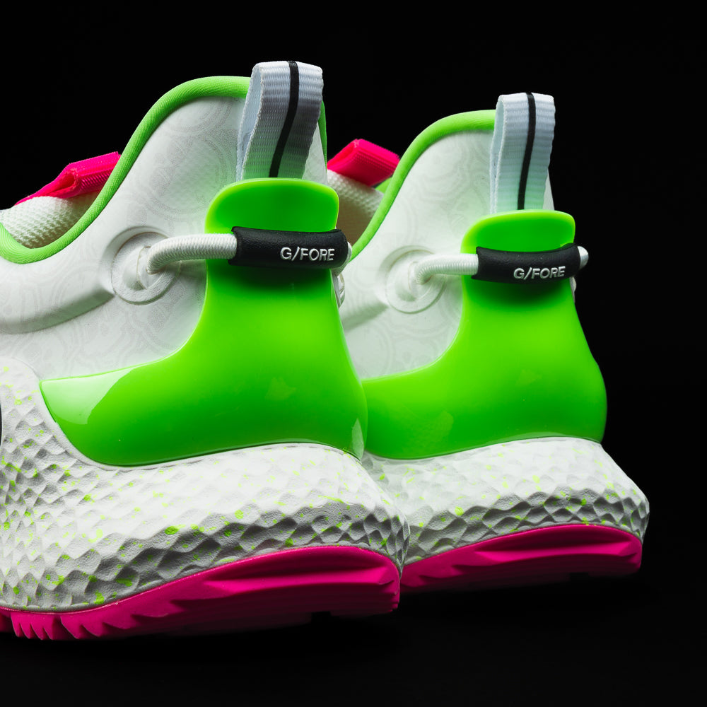 SWAG x G/FORE Men's MG4+ O2 white, neon pink, and neon green golf shoe with stacked SWAG skull design.