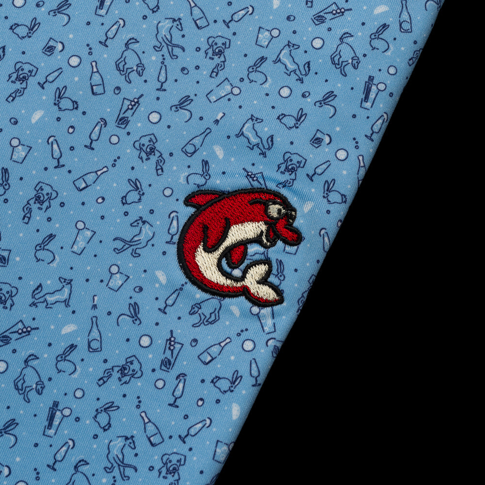 SWAG x Peter Millar blue men's golf polo with animal and cocktail print with red flipper. 