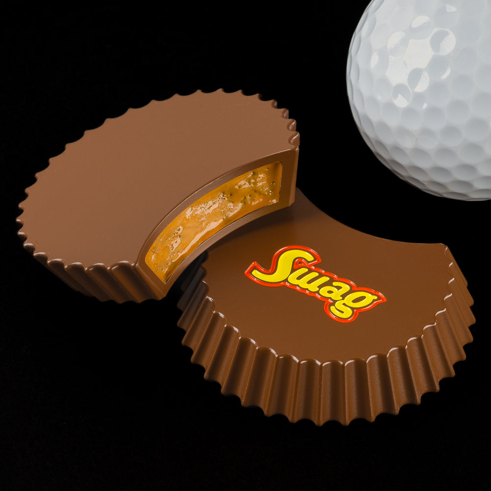 Peanut Butter Cup Ball Marker in brown with Swag in yellow writing with orange outline.