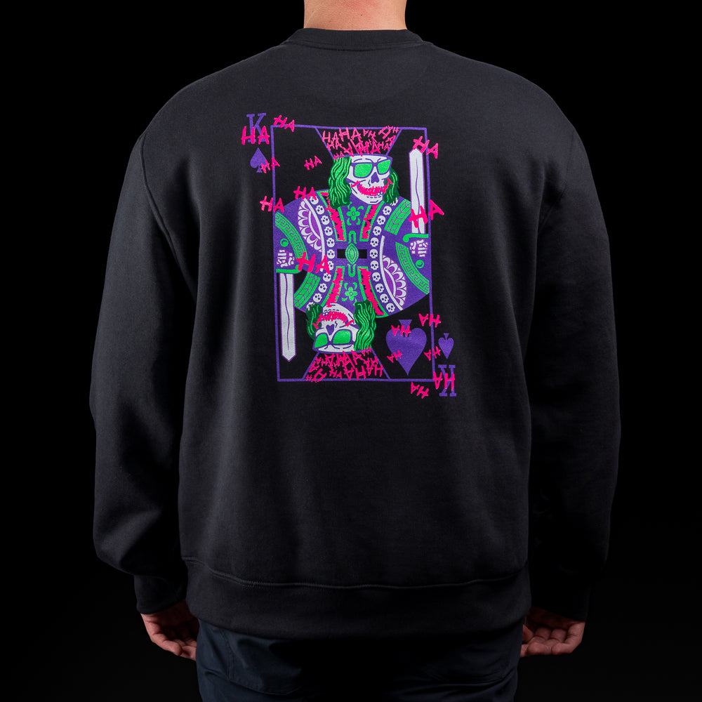 Black crewneck sweater with SWAG chest logo and neon joker skull king graphic on back.