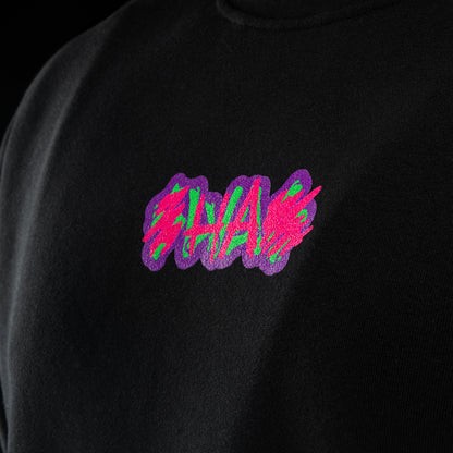 Black crewneck sweater with SWAG chest logo and neon joker skull king graphic on back.