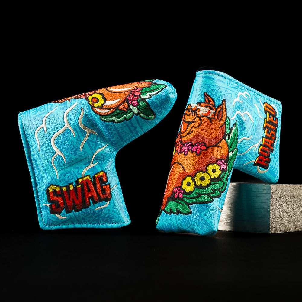 SWAG Golf Pig Roast blade putter cover featuring roasted pig artwork, island florals, and bold blue graphics.