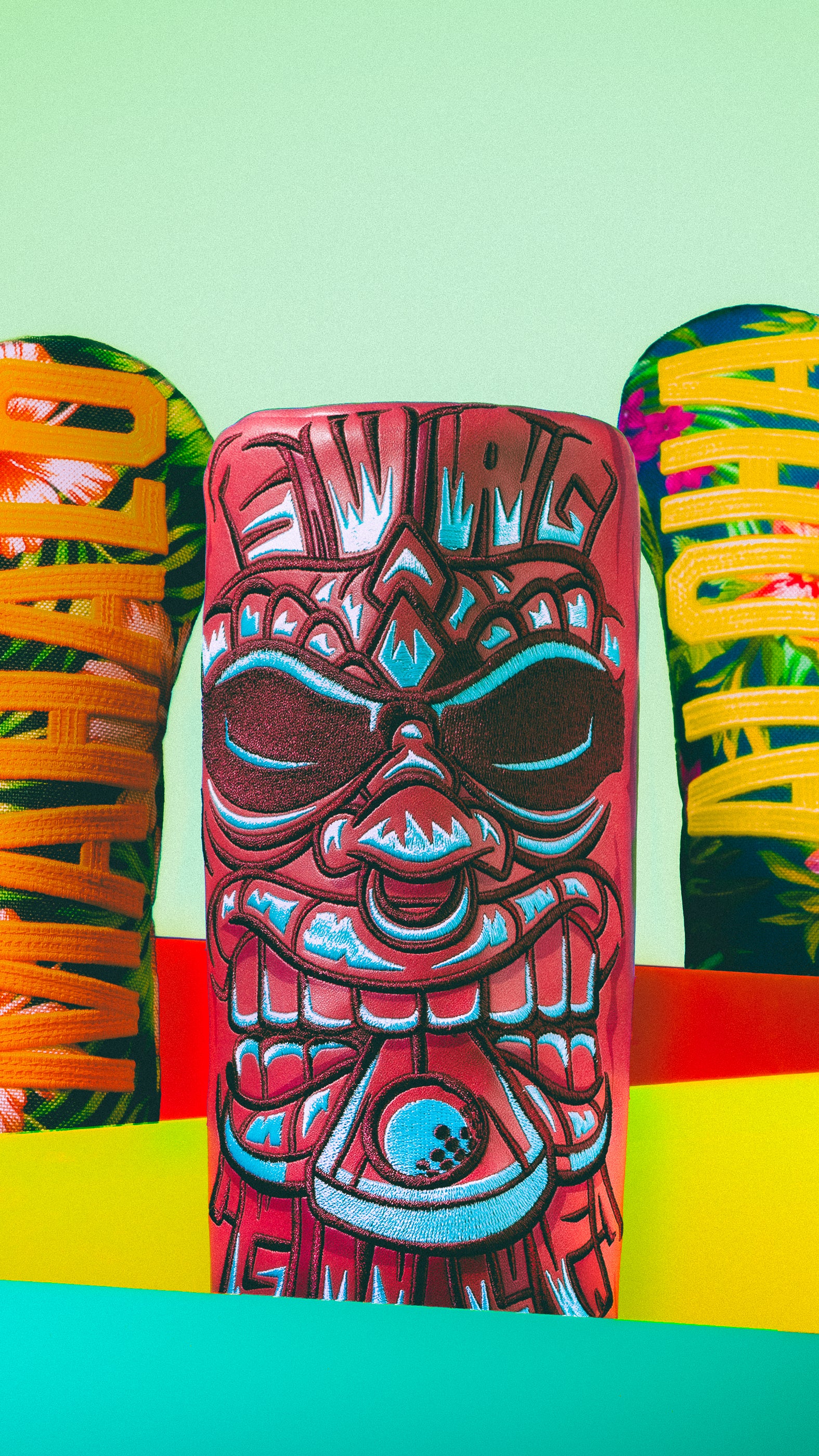 Colorful tiki-themed golf headcover on a vibrant background. SWAG Golf limited edition Hawaii themed golf gear collection.