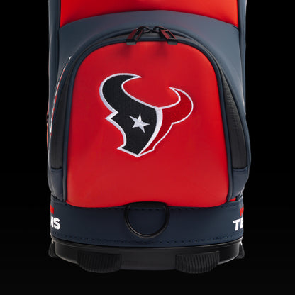 Close-up of the embroidered Houston Texans logo on the front pocket with the charging bull artwork in the background.
