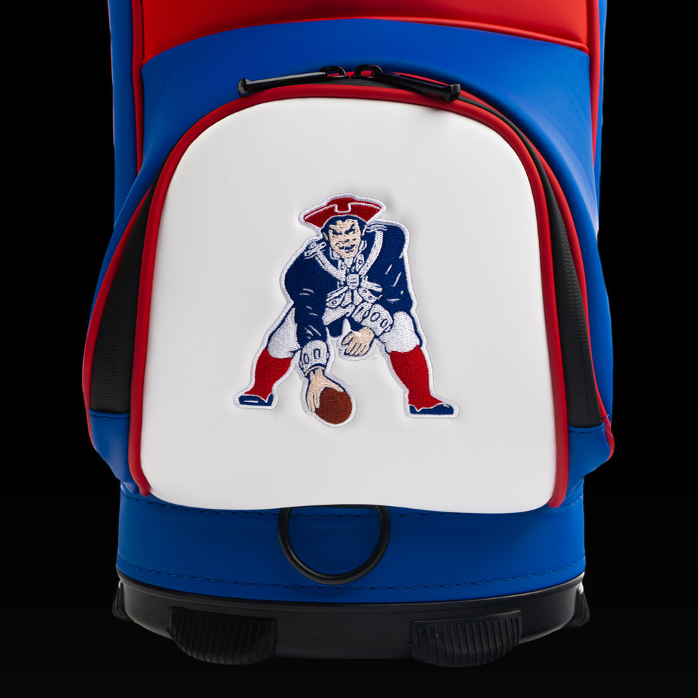 Close-up of the vintage Pat Patriot artwork featuring the iconic mascot holding a football in bold red, white, and blue.