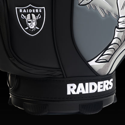 Close-up of the embroidered Raiders shield on the front pocket with the skeleton pirate artwork in the background.