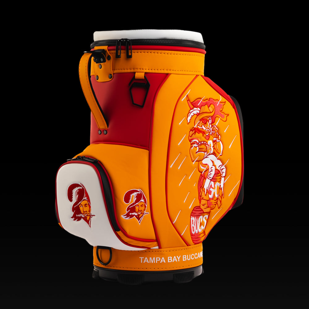 Angled view of the SWAG Golf Tampa Bay Buccaneers Den Caddy Cooler showcasing the vintage Buccaneers pirate artwork and embroidered Buccaneers logo pocket.