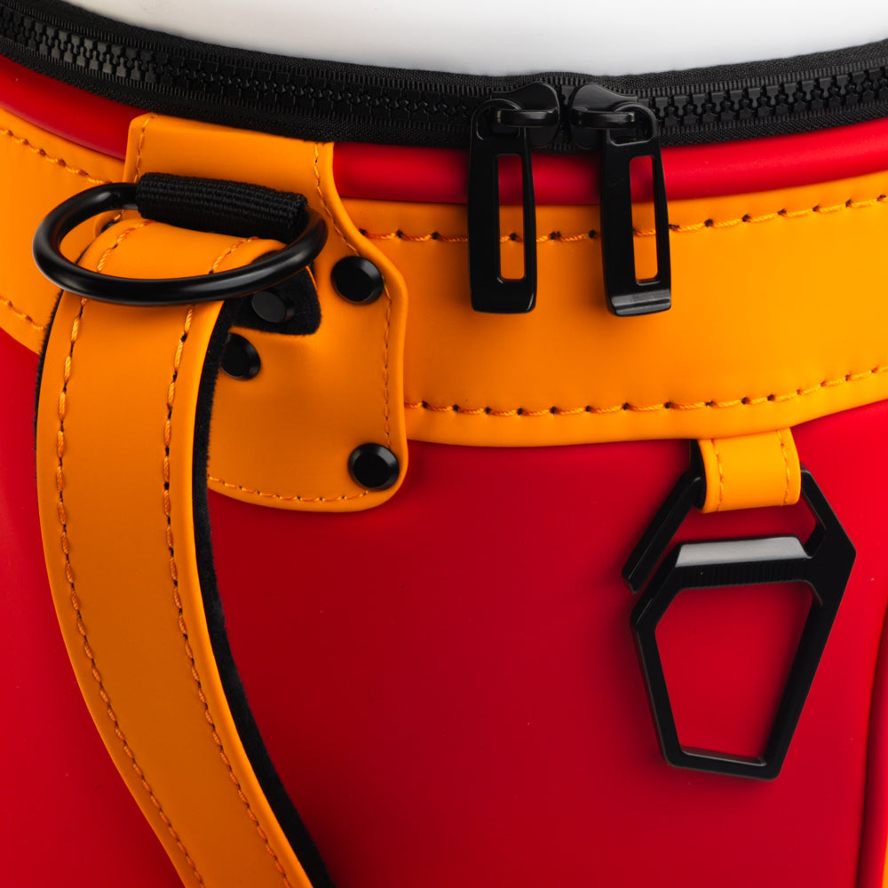 Close-up of the Tampa Bay Buccaneers Den Caddy Cooler zipper, handle, and red and orange panels.