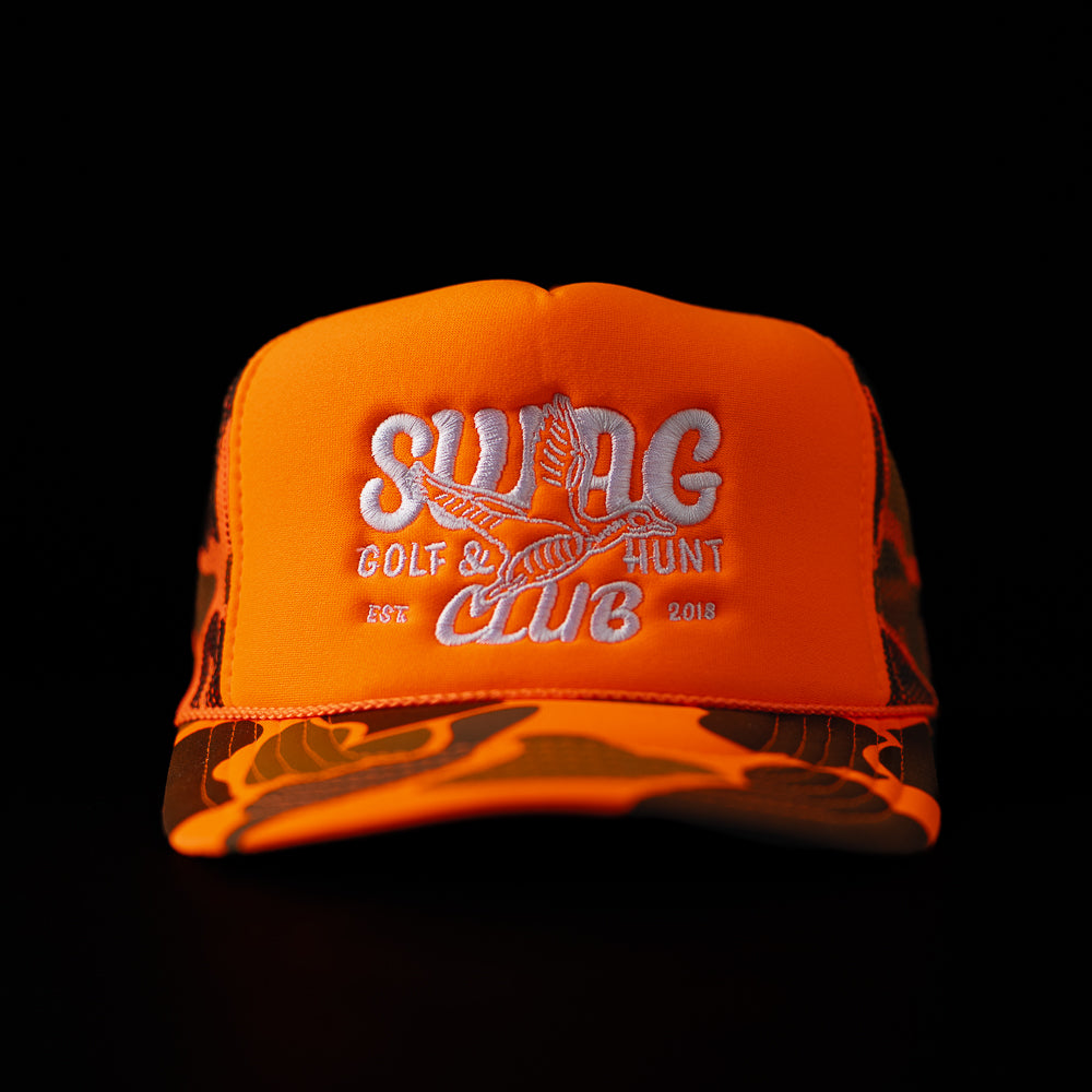 SWAG Hunt Club orange camo foam trucker hat with flying duck graphic and white SWAG logo.