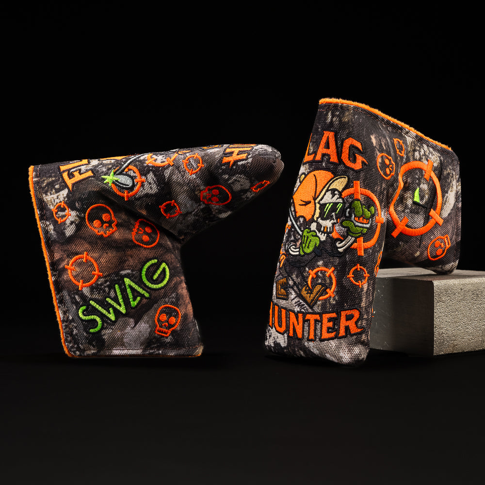 Flag Hunter camouflage golf putter blade headcover with orange and green writing and skull character. 