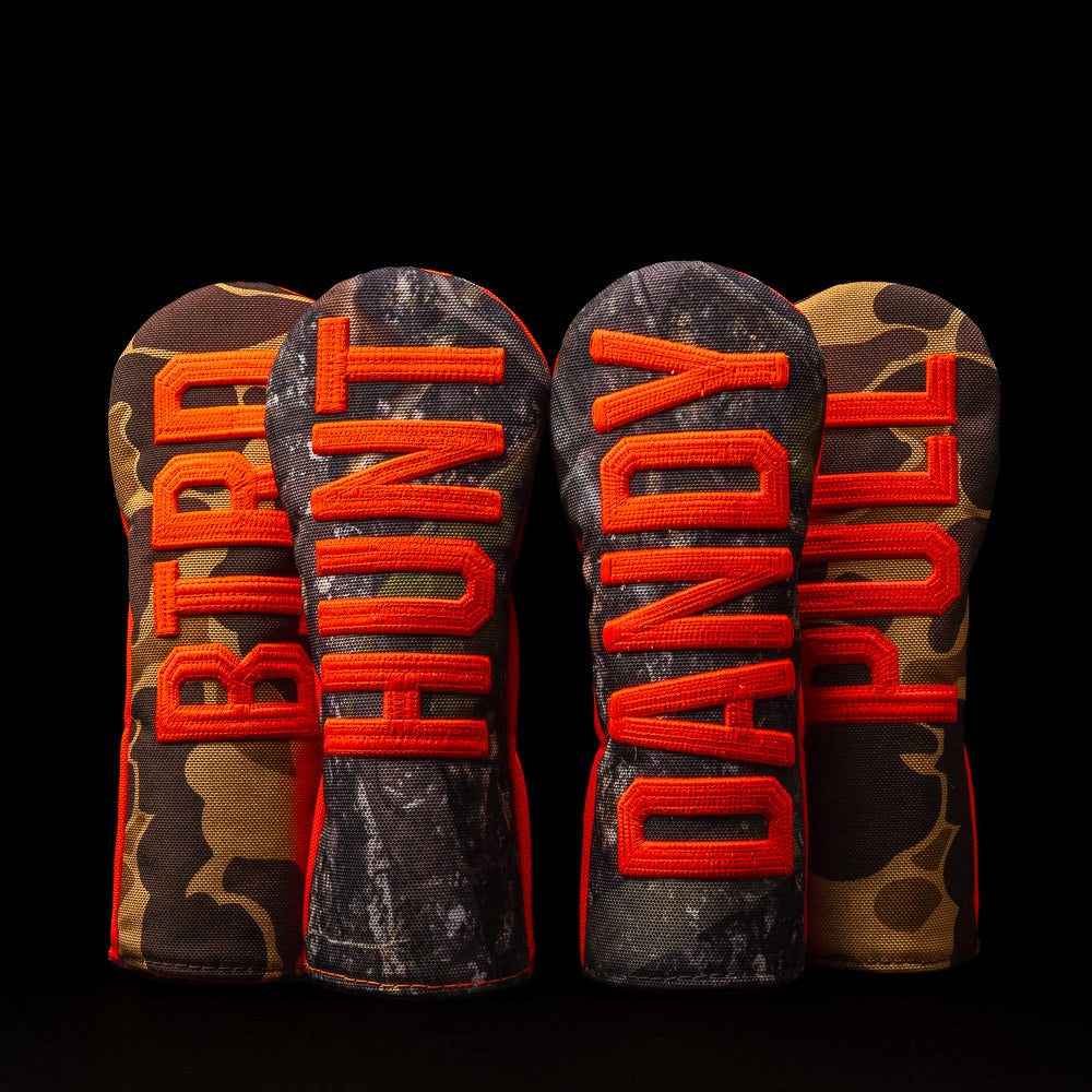 SWAG small talk hunting themed hybrid golf headcover in camo and orange with hunting-themed phrases.