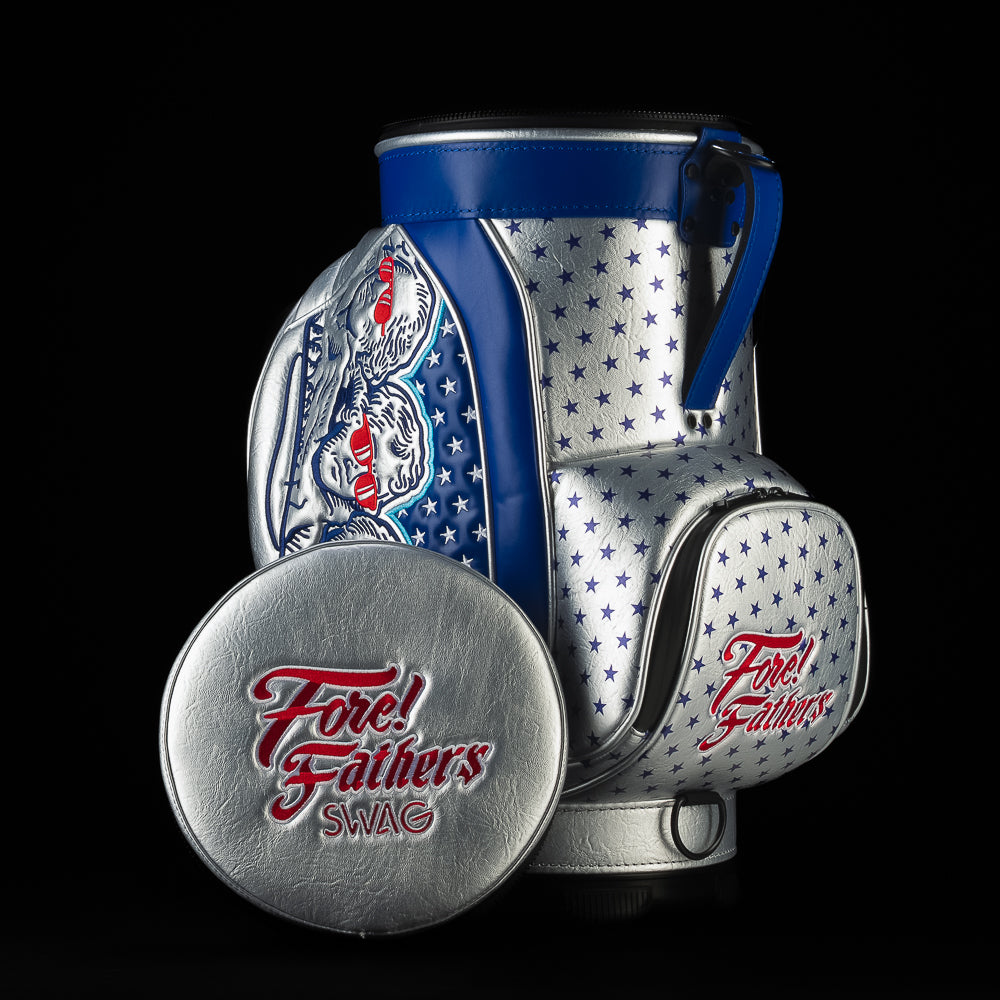 Fore! Fathers Den Caddy Cooler featuring patriotic red, white, and blue graphics with Founding Father illustrations, stars, and embroidered Fore! Fathers logo on the front pocket and lid.