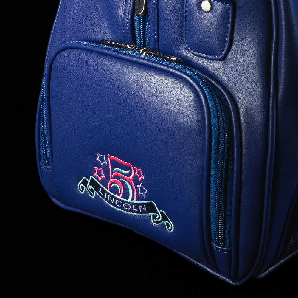 Blue duffel bag with teal handles and strap, featuring a graphic design of Lincoln and the SWAG logo on a black background.