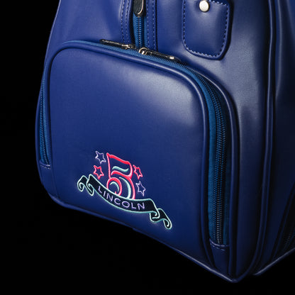 Blue duffel bag with teal handles and strap, featuring a graphic design of Lincoln and the SWAG logo on a black background.