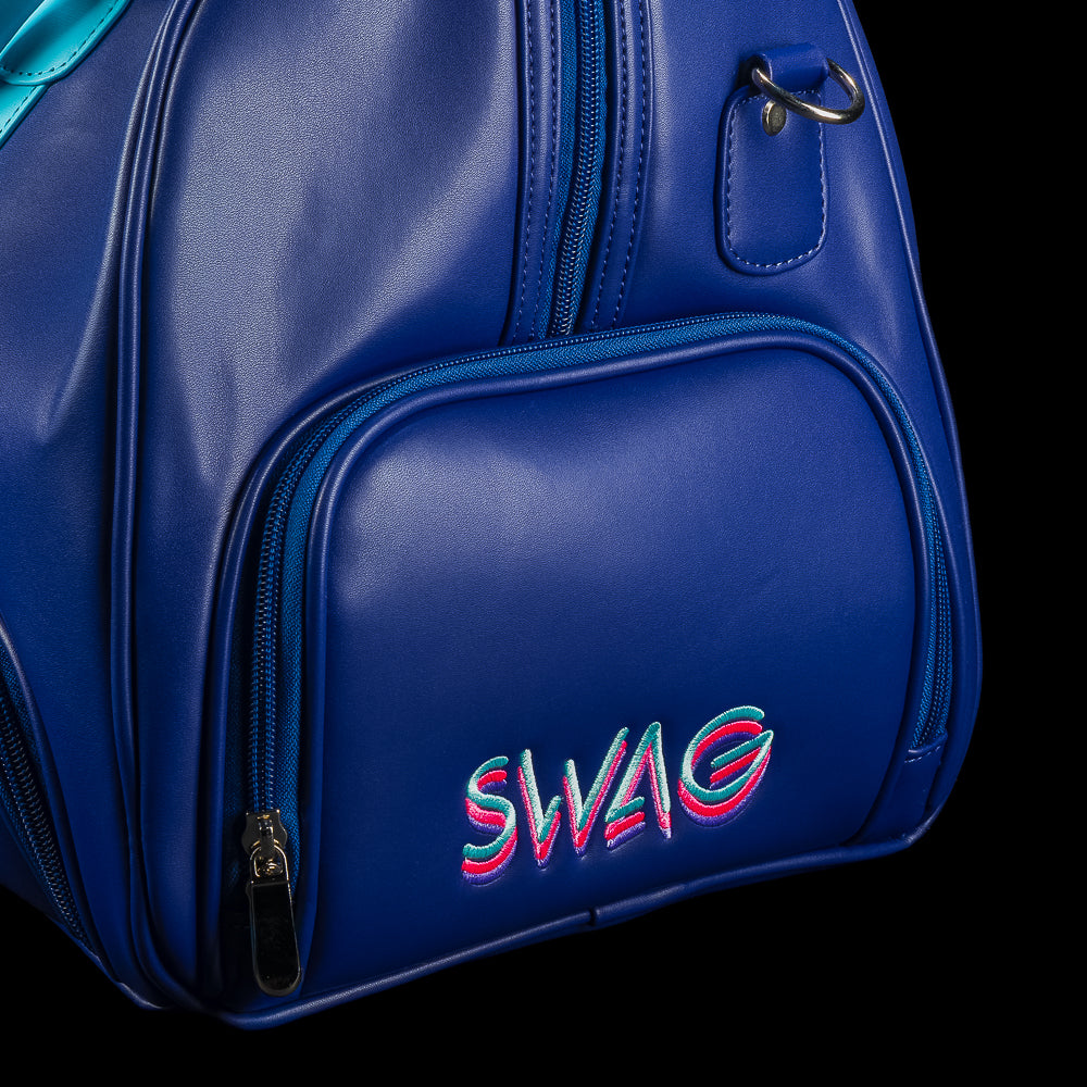 Blue duffel bag with teal handles and strap, featuring a graphic design of Lincoln and the SWAG logo on a black background.