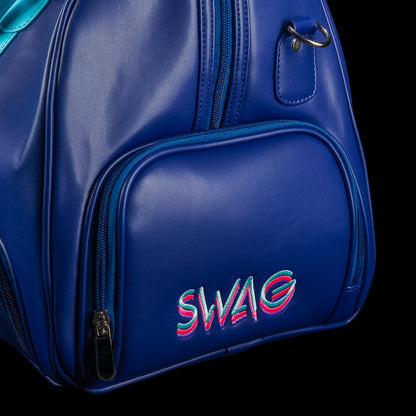 Blue duffel bag with teal handles and strap, featuring a graphic design of Lincoln and the SWAG logo on a black background.