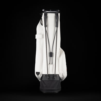SWAG Golf x Vessel white stand bag with Stacked grey and pink flipper designs and "Flip Out" text on the ball pocket.