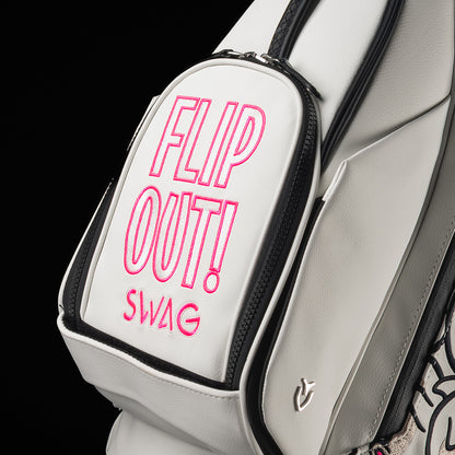 SWAG Golf x Vessel white stand bag with Stacked grey and pink flipper designs and "Flip Out" text on the ball pocket.