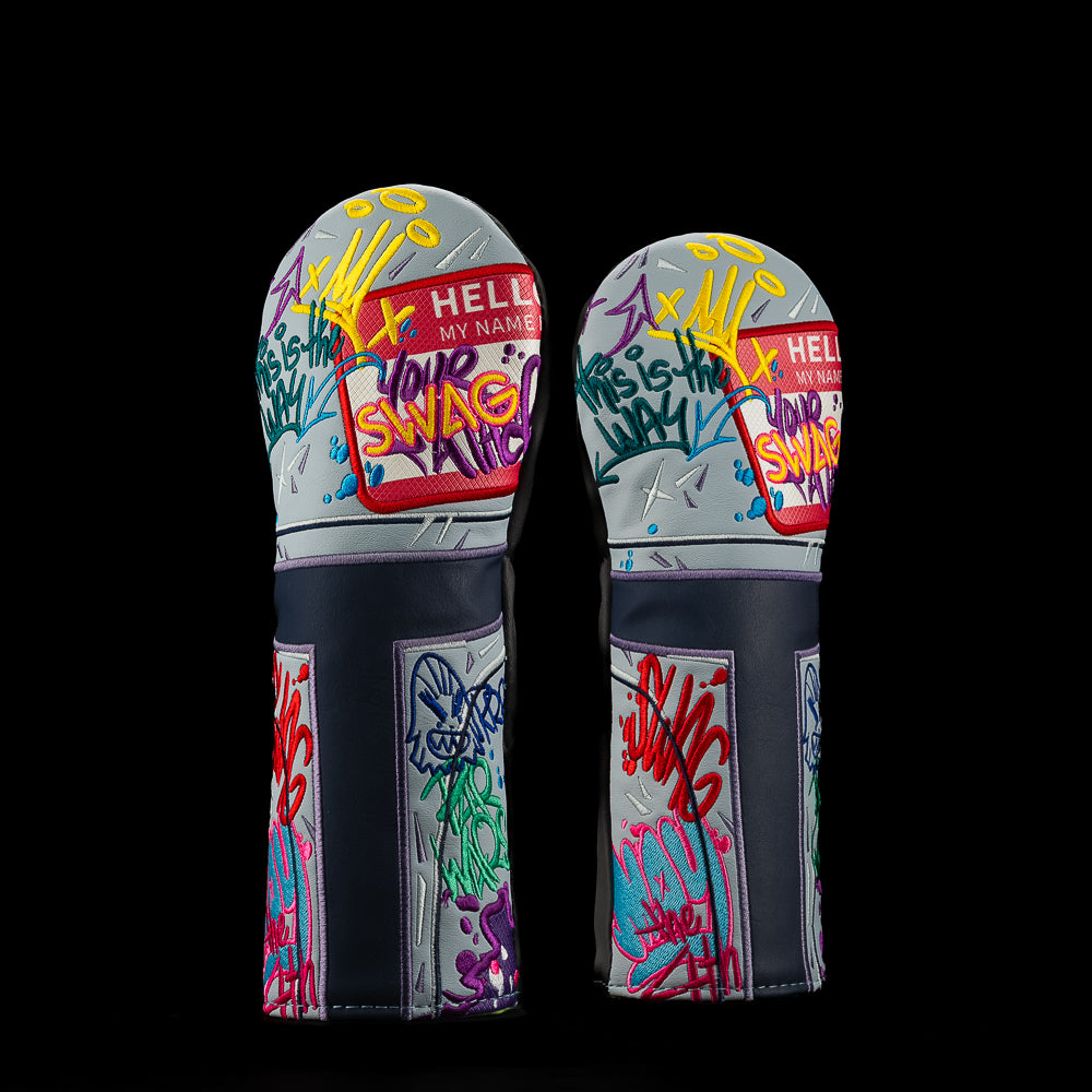 SWAG Golf fairway headcover with gray base covered in colorful graffiti embroidery, including “Hello My Name Is” tag, neon SWAG lettering, handprint graphic, and street art style doodles in pink, yellow, blue, and purple.