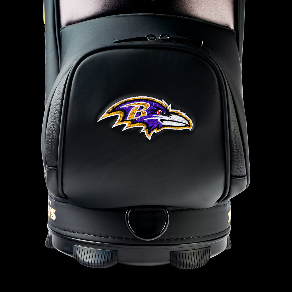 Close-up of the embroidered Baltimore Ravens logo on the front storage pocket with premium black leather and detailed stitching.