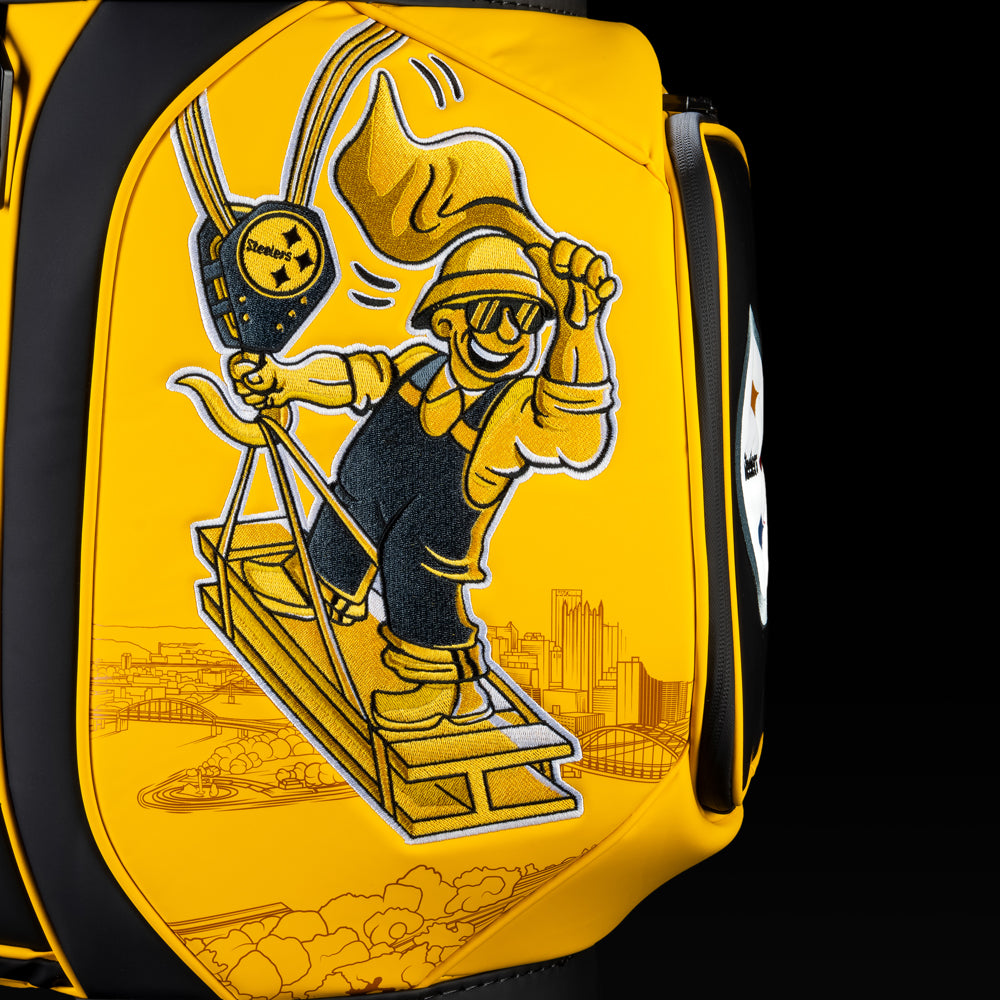 Close-up of the construction worker artwork featuring a hard hat, steel beam, and Pittsburgh skyline in black and gold.