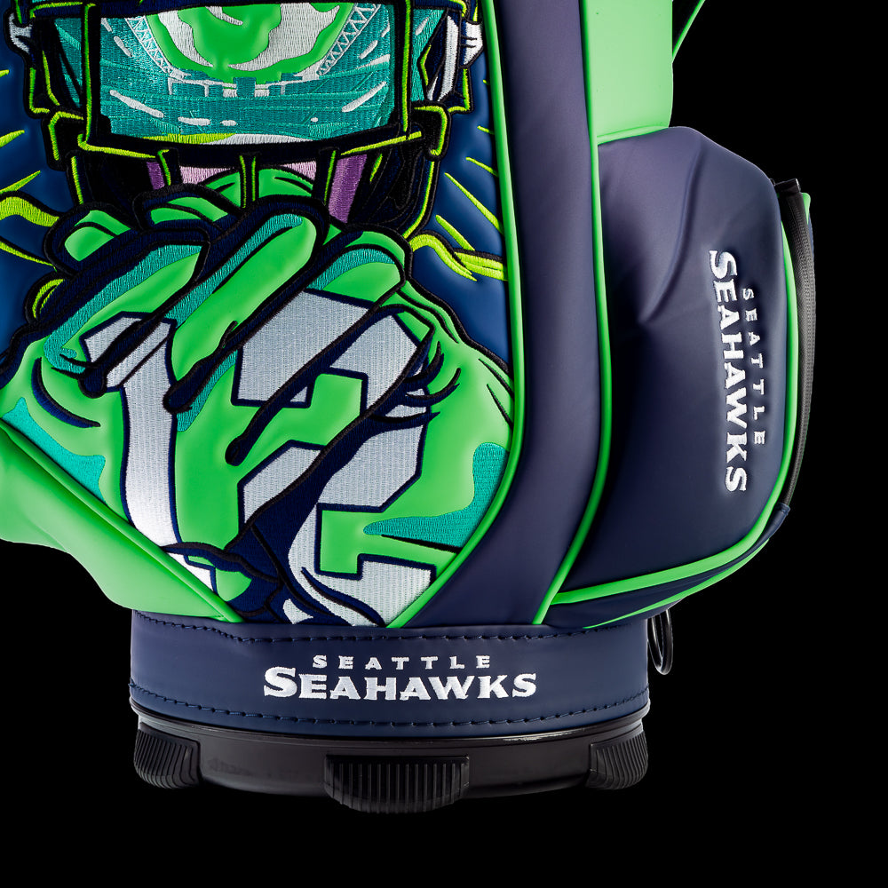Close-up of the embroidered Seahawks logo on the front pocket with the futuristic fan artwork in the background.