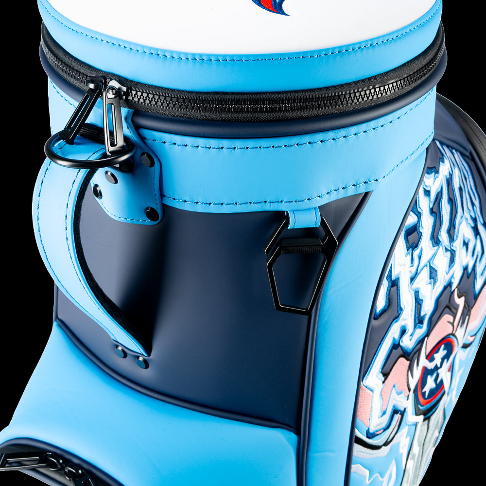 Close-up of the Tennessee Titans Den Caddy Cooler zipper, handle, and navy and Titans blue panels.