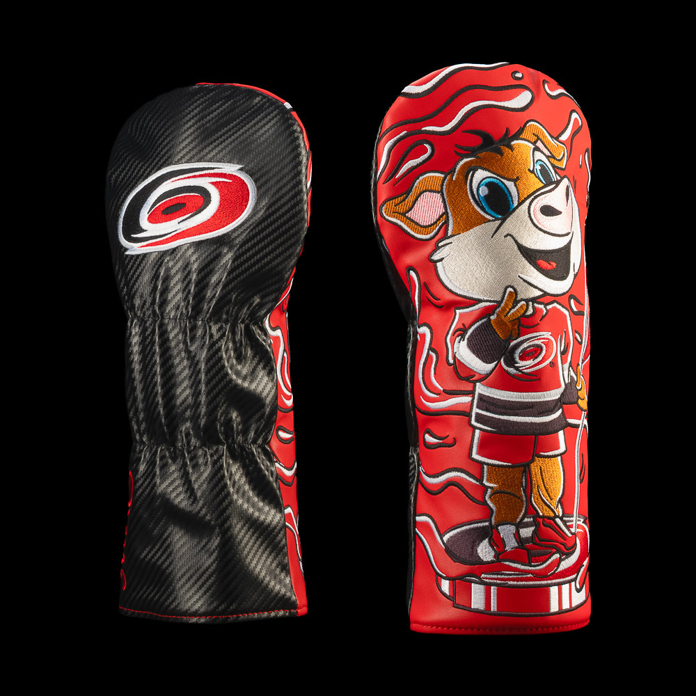 Black and red Carolina Hurricanes driver cover featuring the Carolina Hurricanes logo and smiling pig bobble head hockey character with swirling red lines.