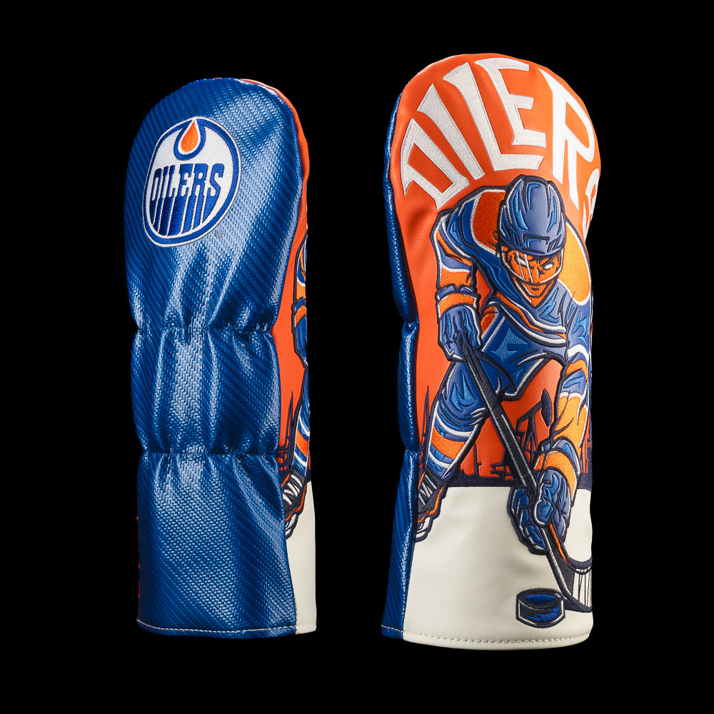 Blue Edmonton Oilers driver cover with oversized Oilers lettering and an orange-and-blue hockey player controlling the puck.