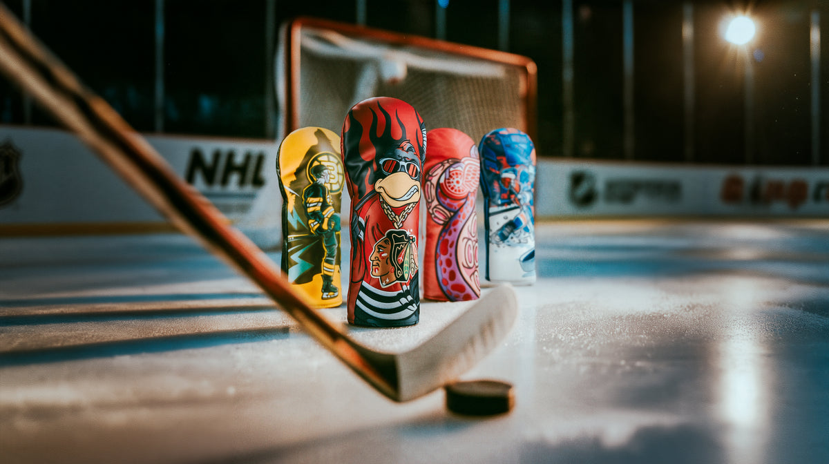 SWAG Golf x NHL official collection featuring headcovers for all US and Canada hockey teams. Hockey rink setting featuring Chicago Blackhawks, Boston Bruins, Detroit Red Wings, and New York Rangers driver covers.