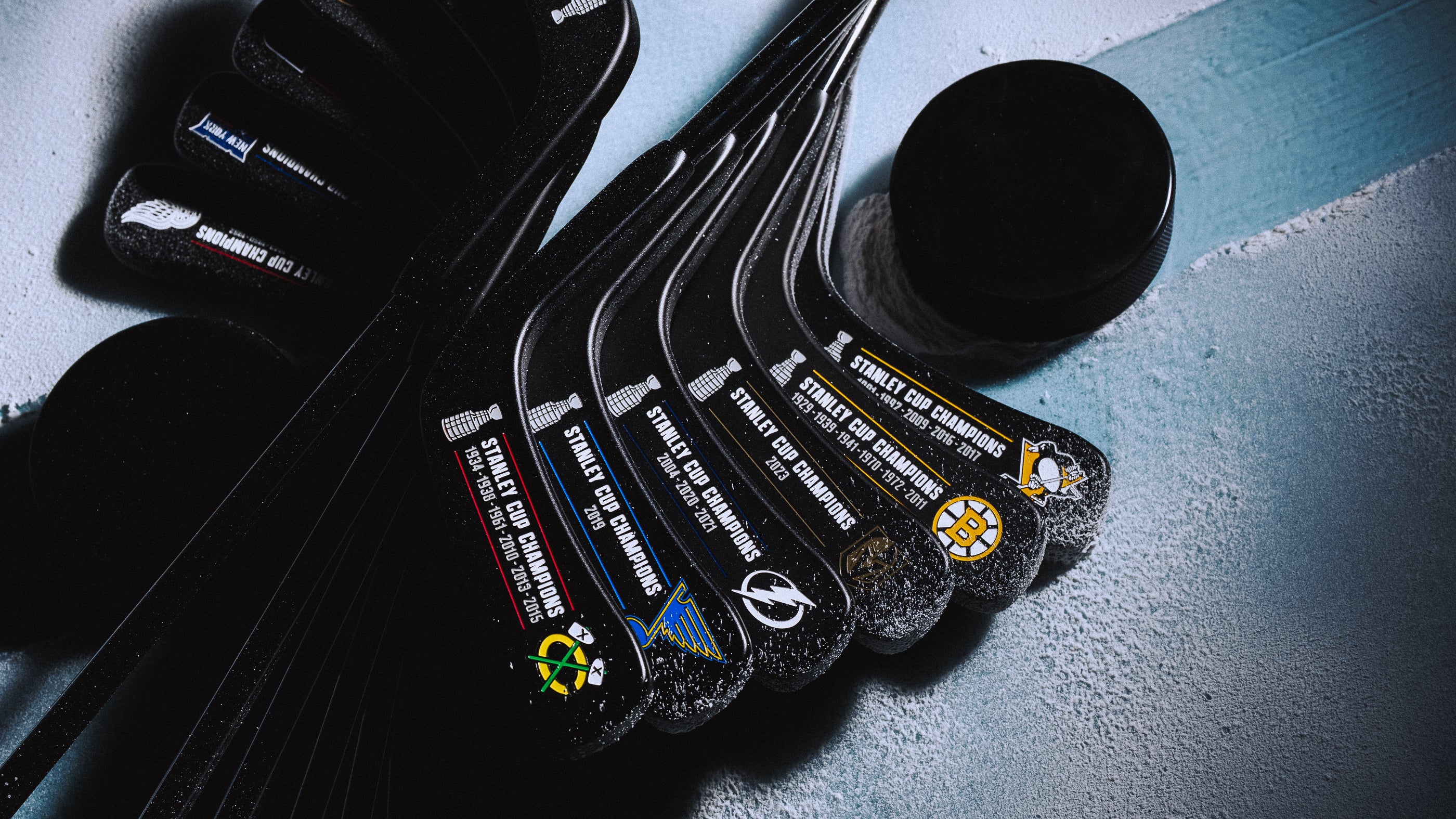 SWAG x NHL official hockey team blade putters with a black nano coating and matching headcover.
