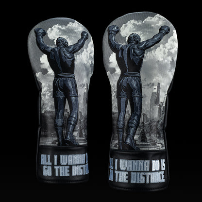 Black and gray SWAG Golf Let Freedom Ring driver cover featuring victory pose artwork, cityscape background, and “All I Wanna Do Is Go The Distance” embroidery.