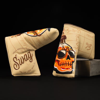 Whiskey bottle skull in orange with green, brown, yellow and tan blade putter golf club head cover made in the USA.