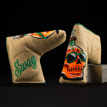 Whiskey bottle skull in orange with green, brown, yellow and tan blade putter golf club head cover made in the USA.