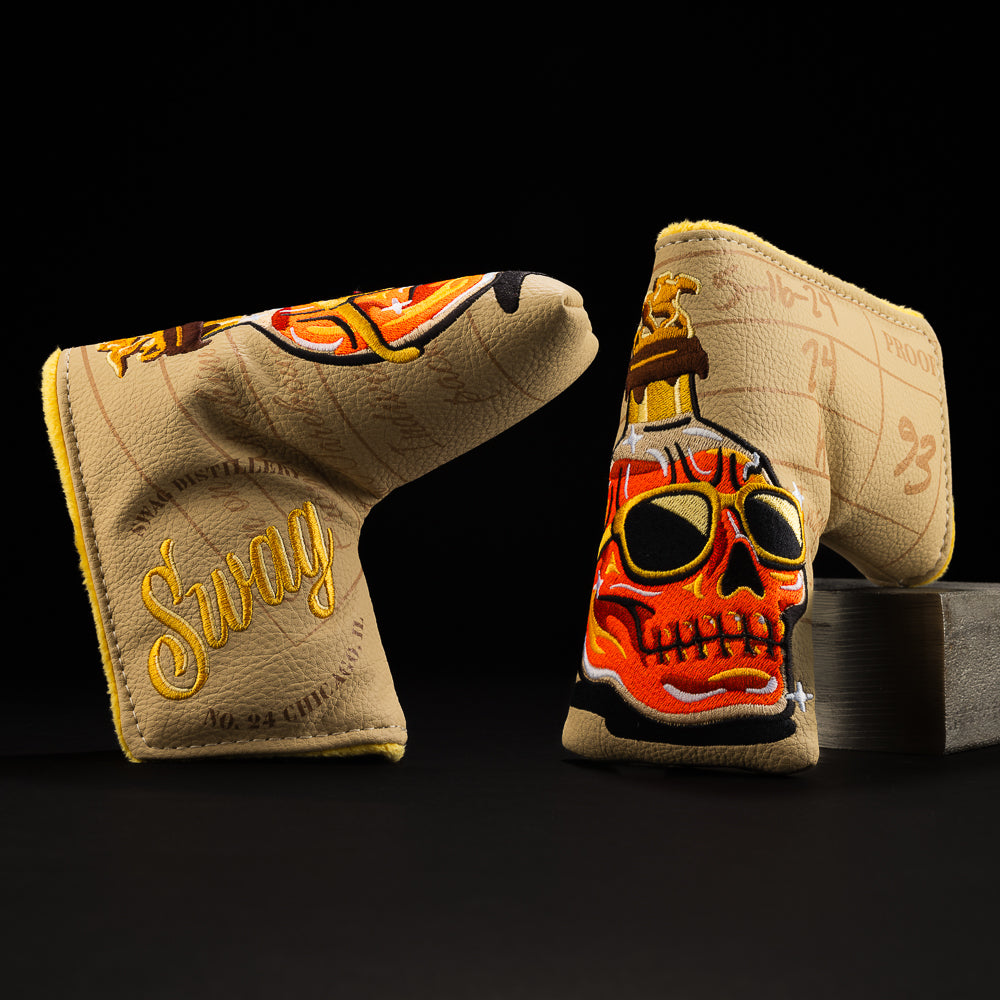 Whiskey bottle skull in orange with green, brown, yellow and tan blade putter golf club head cover made in the USA.