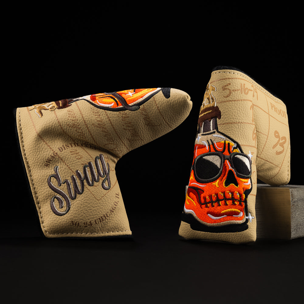 Whiskey bottle skull in orange with green, brown, yellow and tan blade putter golf club head cover made in the USA.