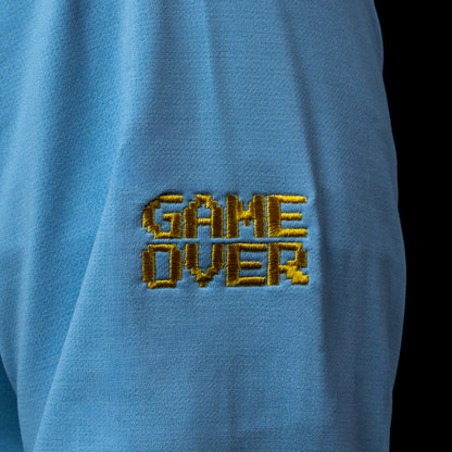 SWAG Golf x Peter Millar sky blue performance hoodie with 8-bit skull and game over embroidery on the left sleeve. 
