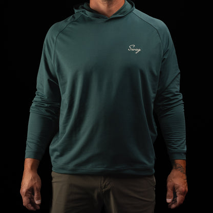 Person wearing a nordic green long sleeve performance golf hoodie with 'Swag' logo.