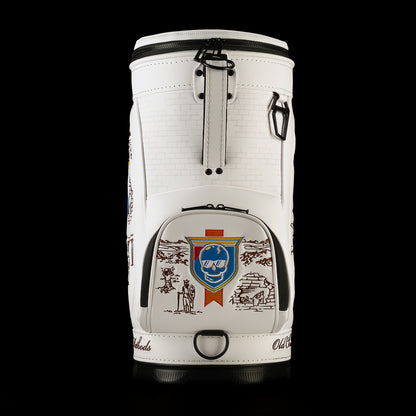 Side profile of the Old SWAG Den Caddy Cooler featuring a white brick pattern, carrying strap hardware and zippered pocket decorated with a blue skull shield and vintage Chicago scenes.