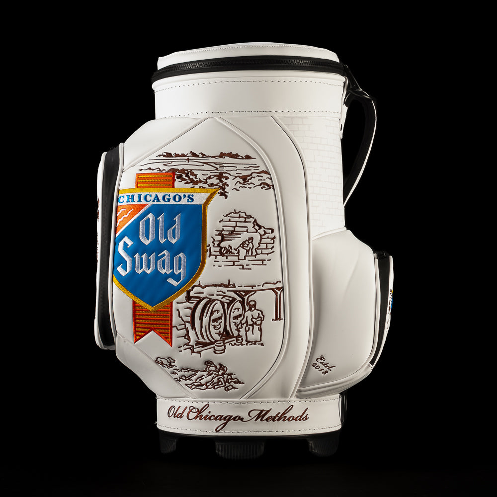 Left-side view of the Old SWAG Den Caddy Cooler featuring the embroidered Chicago’s Old Swag shield, brown vintage illustrations, black carrying handle and “Old Chicago Methods” script.