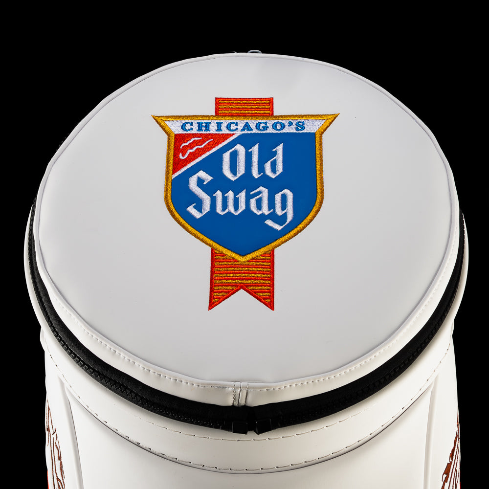 Close-up of the round white lid on the Old SWAG Den Caddy Cooler featuring an embroidered blue Chicago’s Old Swag shield with gold trim and a red striped ribbon.
