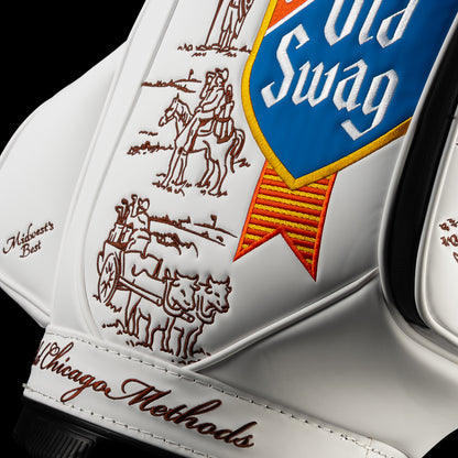Close-up of the Old SWAG Den Caddy Cooler featuring the blue and gold shield, red ribbon, brown illustrations of a horseback rider and “Old Chicago Methods” script.