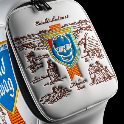 Close-up of the zippered pocket on the Old SWAG Den Caddy Cooler featuring a blue skull shield, brown Chicago-inspired illustrations and “Established 2018” and “Midwest’s Best” embroidery.