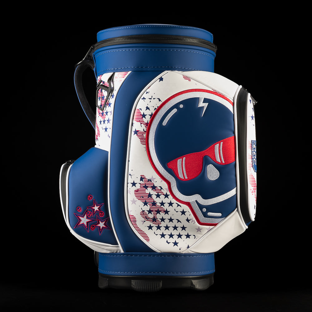Right-side view of the USA Skull Stars & Stripes Den Caddy Cooler showing the skull-and-sunglasses design, navy trim, patriotic star pattern and embroidered side pocket.