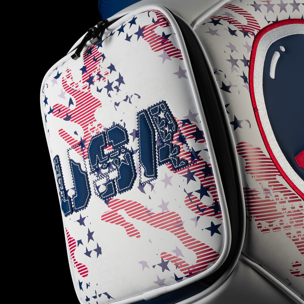Close-up of the white zippered pocket on the USA Skull Stars & Stripes Den Caddy Cooler featuring navy USA lettering, a skull detail and scattered red, navy and silver stars.