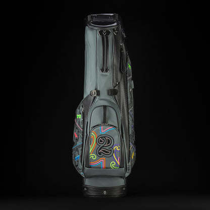 Gray SWAG Golf x Vessel golf stand bag with colorful dollar bill themed designs on a black background.