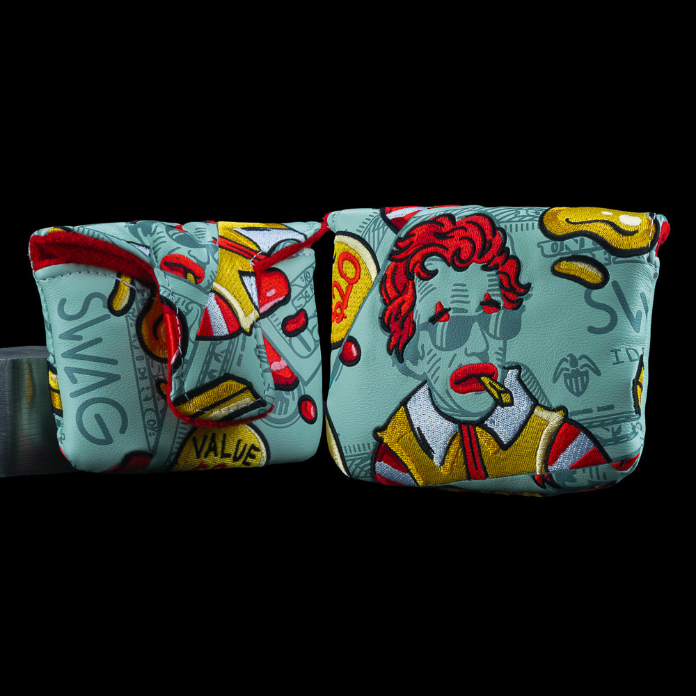 SWAG Golf McFlation Mallet Cover featuring vandalized dollar bill artwork, fast food inspired cartoon portrait with red hair and sunglasses, dripping accents, and bold red and yellow detailing.