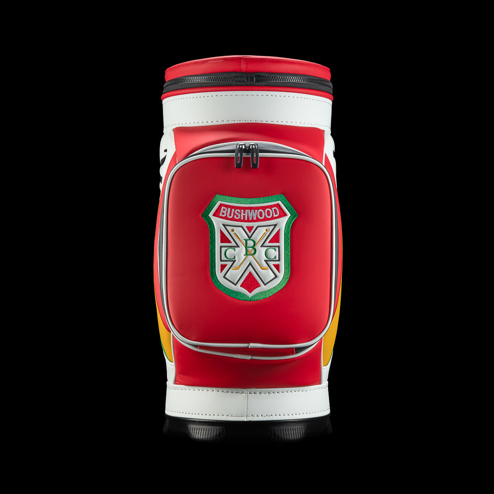 Front view of the Czervik Den Caddy Cooler featuring a red zippered pocket with a Bushwood crest, white trim, and a black base.