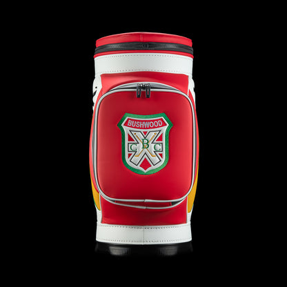 Front view of the Czervik Den Caddy Cooler featuring a red zippered pocket with a Bushwood crest, white trim, and a black base.