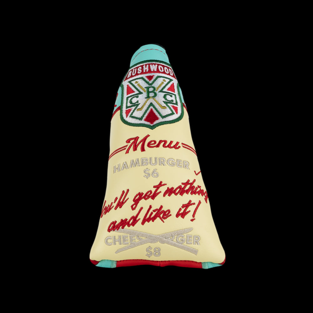 Front of Rewind Golf Caddyshack Halfway House Menu blade headcover with Bushwood crest and “You’ll get nothing and like it!” lettering.